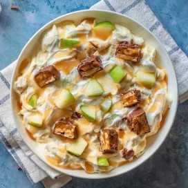 The Snickers salad is a blend of Snickers bars, Granny Smith apples, whipped cream and vanilla pudding that is popular in Iowa. #AmericanRecipe #AmericanFood #AmericanCuisine #WorldCuisine #196flavors