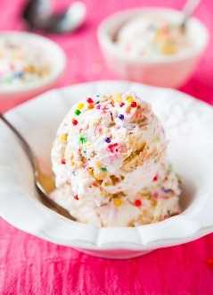 two scoops of Cake Batter Ice Cream in a white bowl with a spoon
