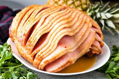 A close-up of the baked ham with a brown sugar glaze.