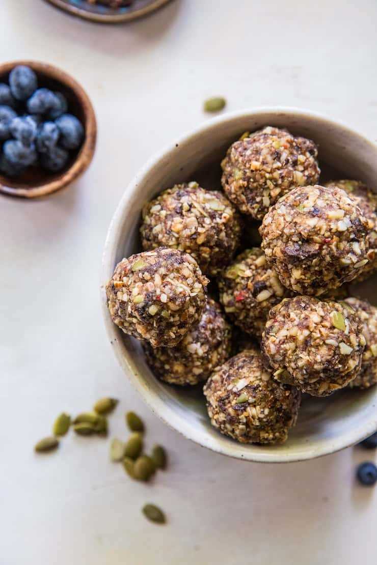 Superfood Blueberry Dark Chocolate Energy Balls made with walnuts, almonds, dates, flax seed oil, and more! A healthy snack recipe