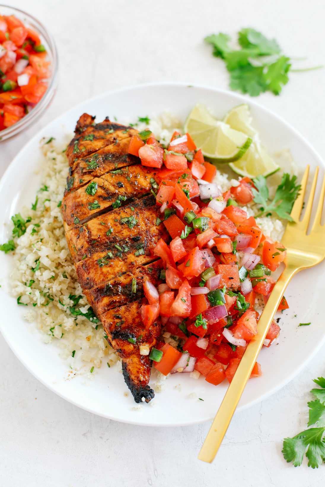 This Chili Lime Grilled Chicken is juicy, flavorful and marinated in a delicious combination of spices making this the perfect summer recipe!  Pair it with fresh salsa and cauliflower rice for a complete meal! 