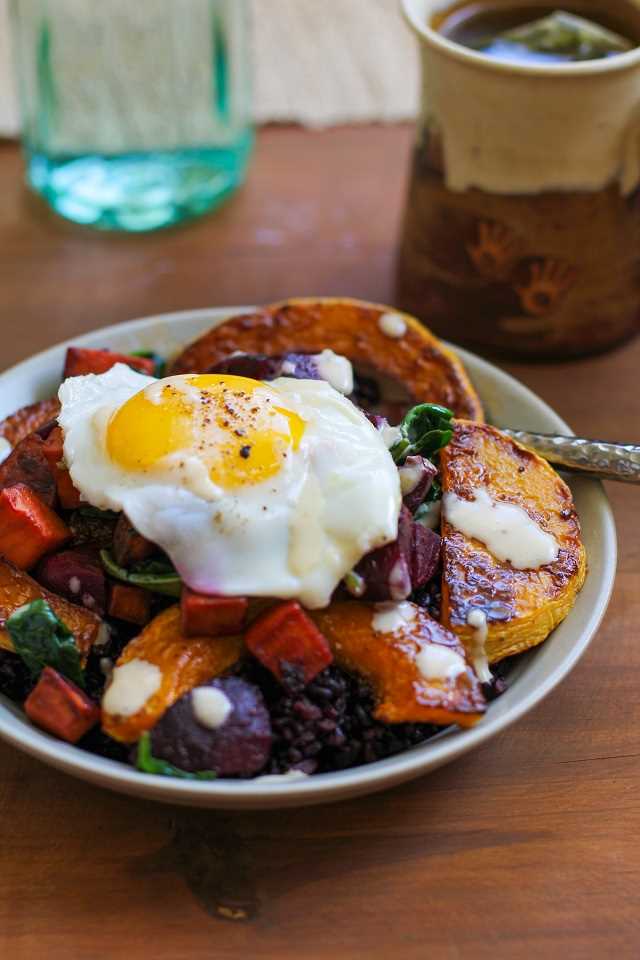 Roasted butternut squash, beet, and sweet potato forbidden rice bowls with maple tahini sauce