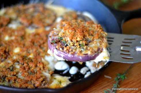 red onion gratin in a cast iron skillet