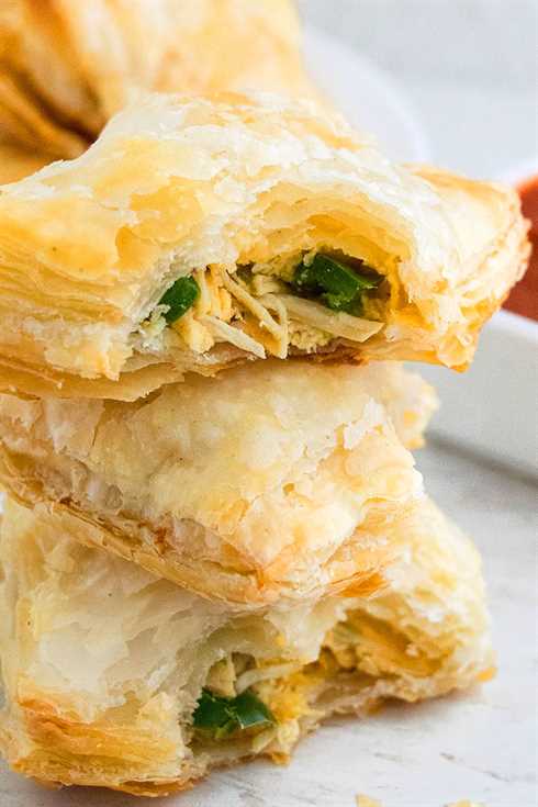 Stack of Chicken Puff Pastry with Partial Bite on One Puff