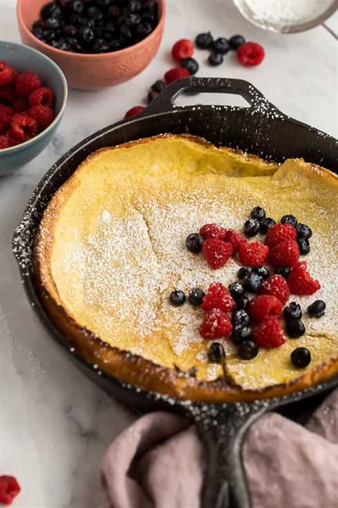 dutch baby pancake in skillet with berries