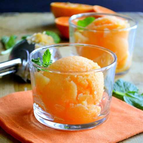 healthy one ingredient tangerine sorbet in small glass bowls with mint sprigs