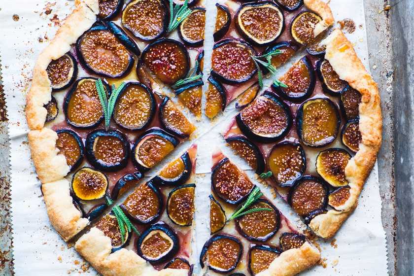 Fig galette with lavender honey sliced into wedges on parchment paper