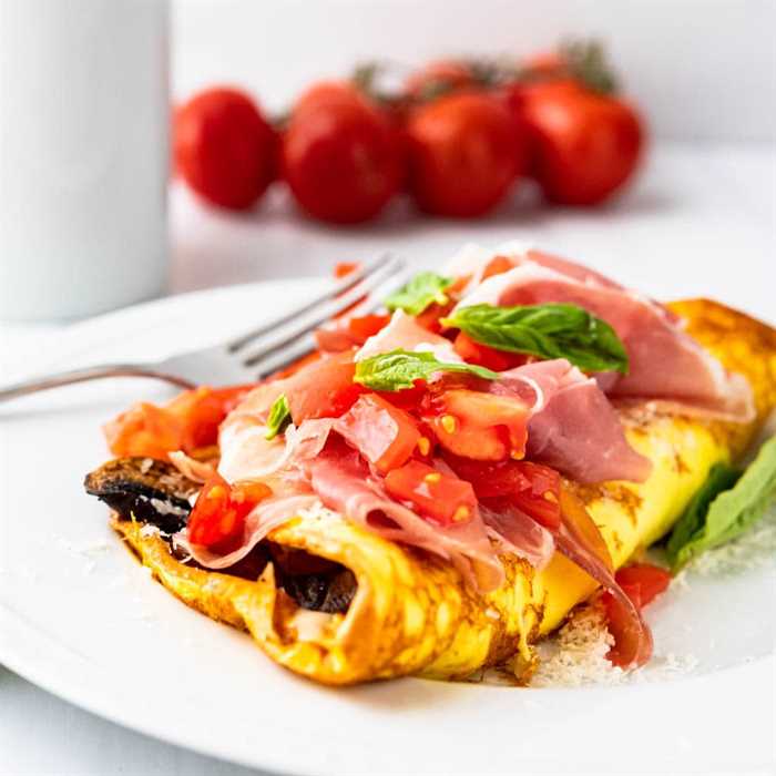 Closeup photo of Italian mushroom tomato and prosciutto omelette with cheese.