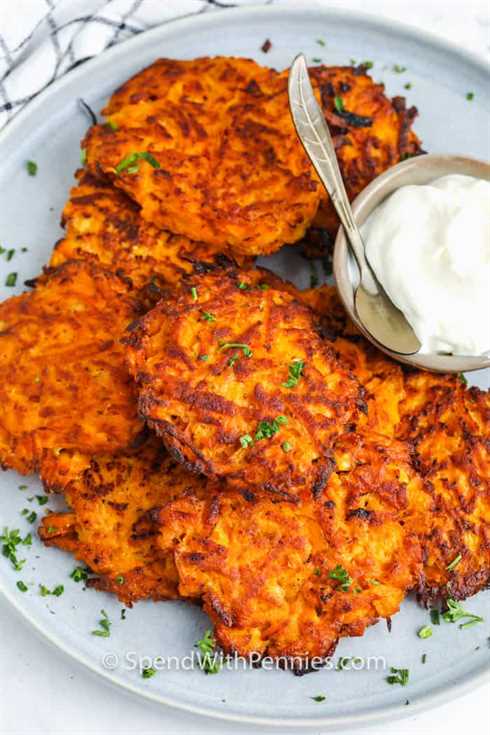 Sweet Potato Hash Browns on a plate with a bowl of sour cream beside it