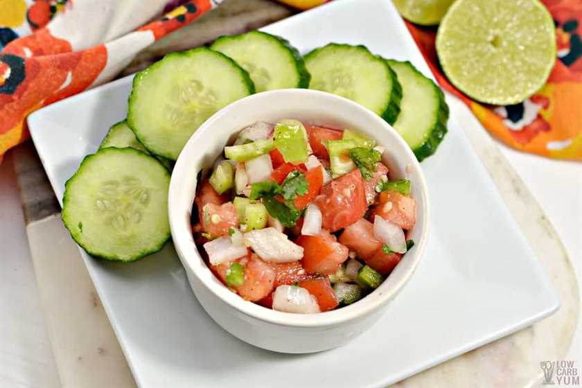 fresh salsa in small bowl with cucumber slices