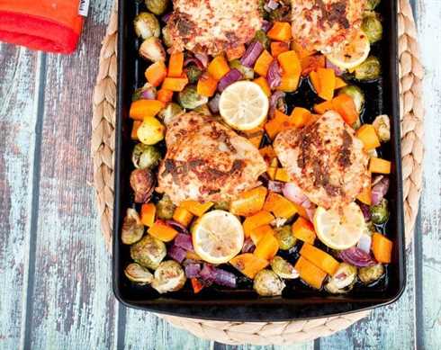 One-Pan Roasted Chicken with Butternut Squash and Brussels Sprouts on a sheet pan.