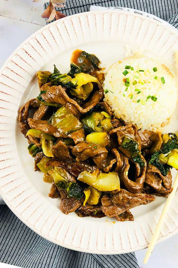 Instant Pot Ginger Beef Served in White Plate With Steamed Rice- Overhead Shot