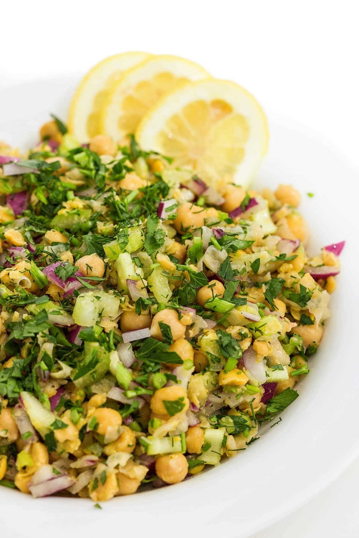 Smashed chickpea salad with dill on a plate.