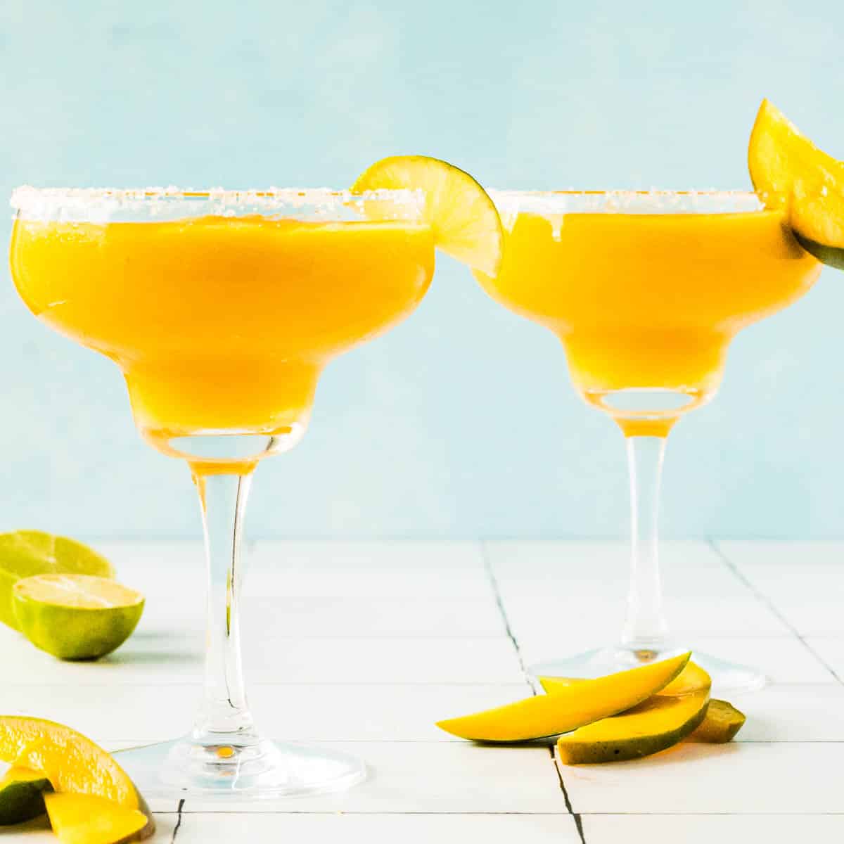 two Mango Margaritas in glasses with salted rim