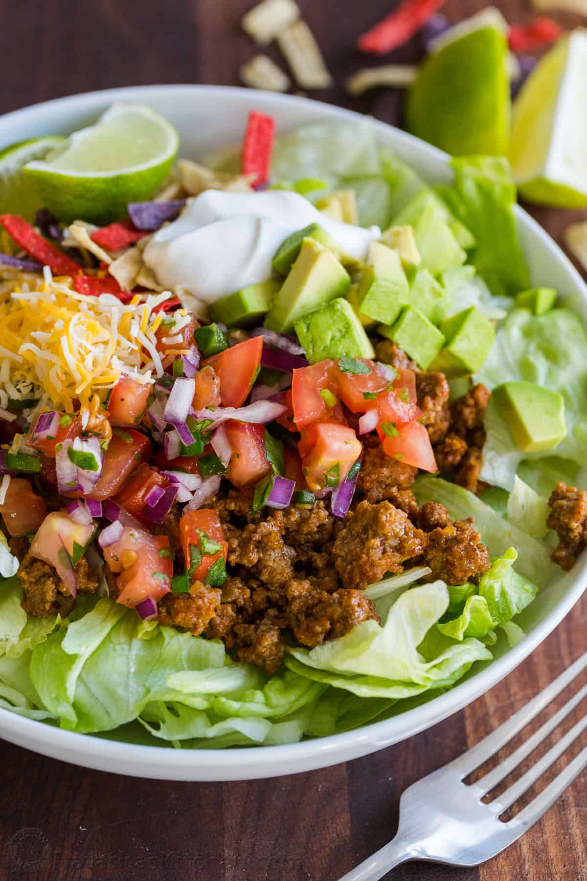 Taco salad served in a bowl with toppings