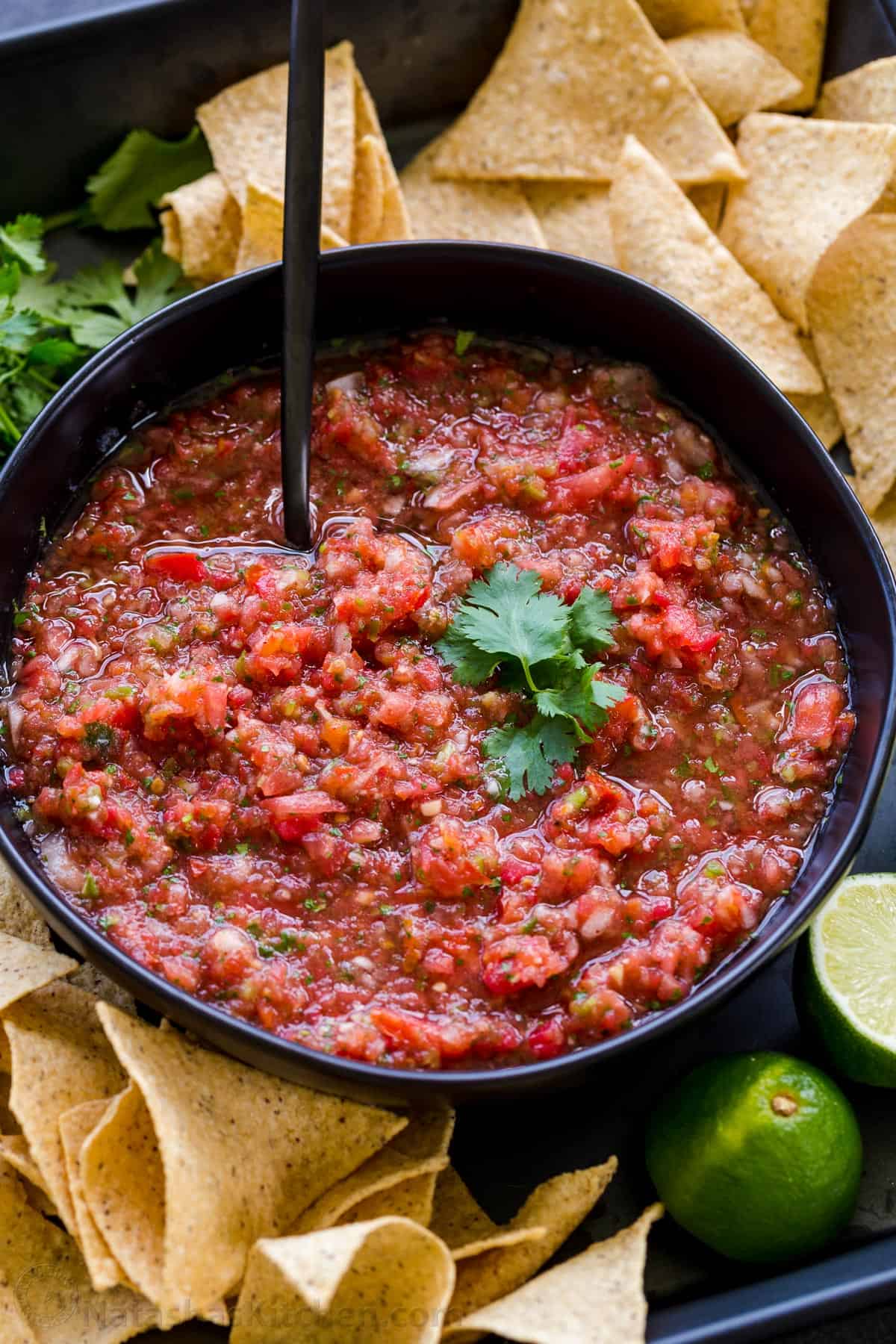 Fresh homemade salsa recipe served in a bowl garnished with cilantro