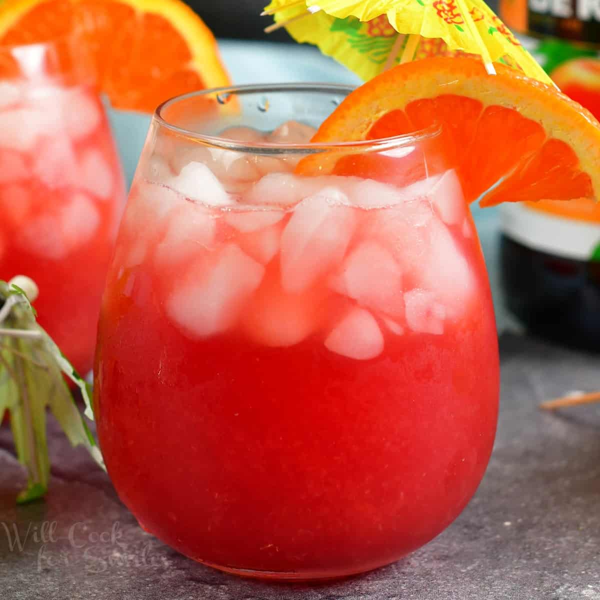 squared off image of bright pink cocktail in a glass
