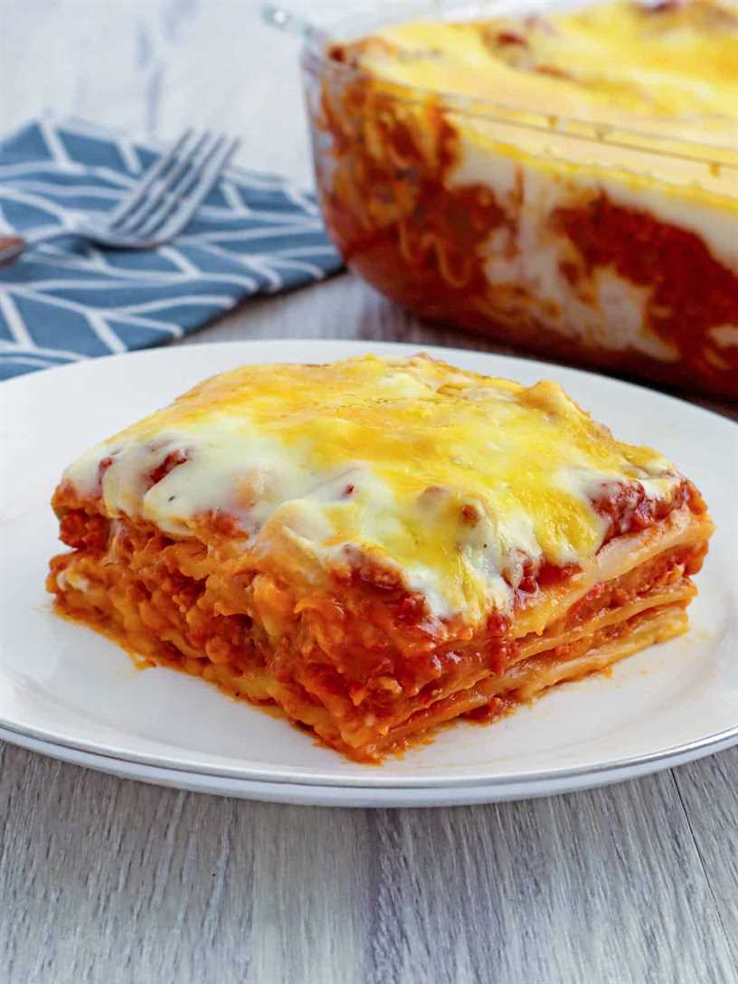 Cheesy lasagna with bechamel sauce layers from a baking dish with a spatula