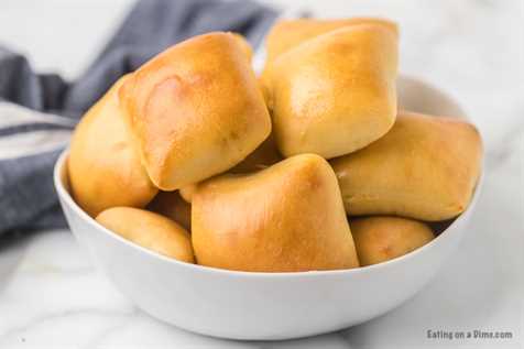Serving bowl of rolls piled high.