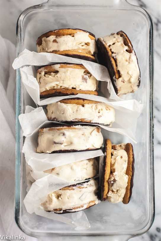 Ice cream sandwiches inside a clear dish separated by parchment paper