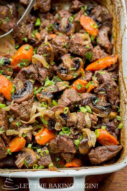 Beef Roast recipe with mushrooms, onions and carrots in a baking dish, top view.
