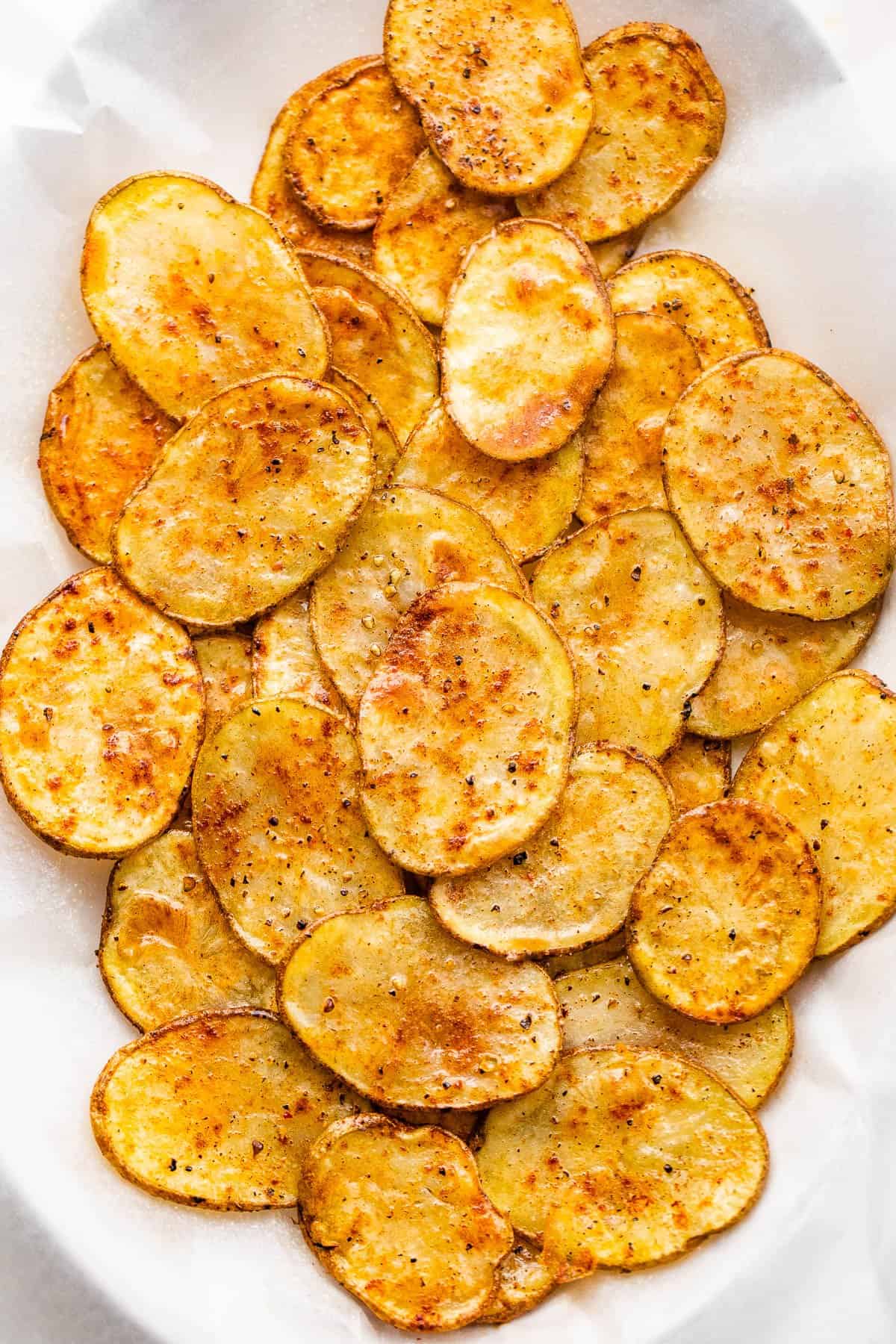 air fryer potato chips arranged on a white background