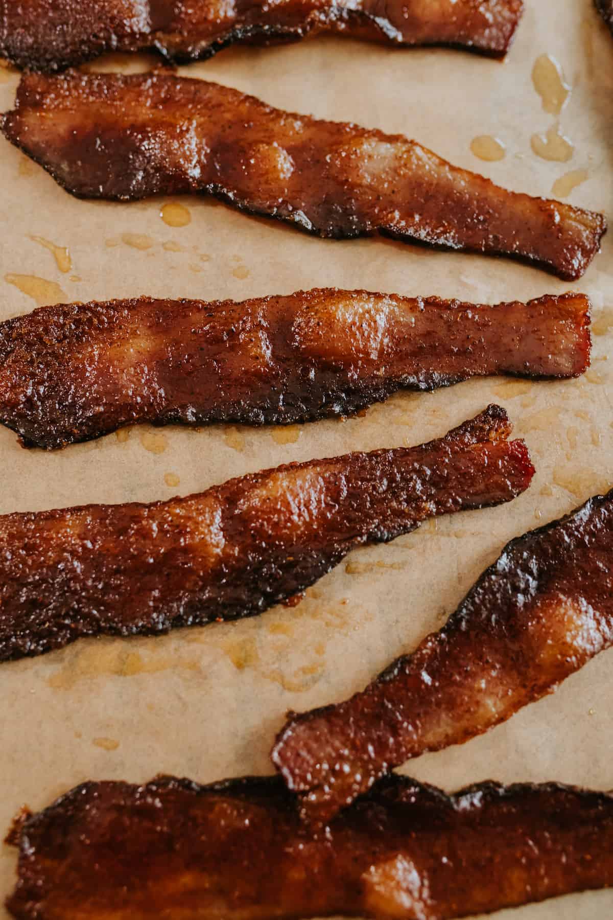 Spicy Maple Candied Bacon on brown parchment paper