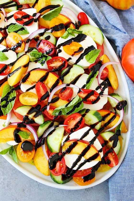 Summer caprese salad on platter with balsamic glaze