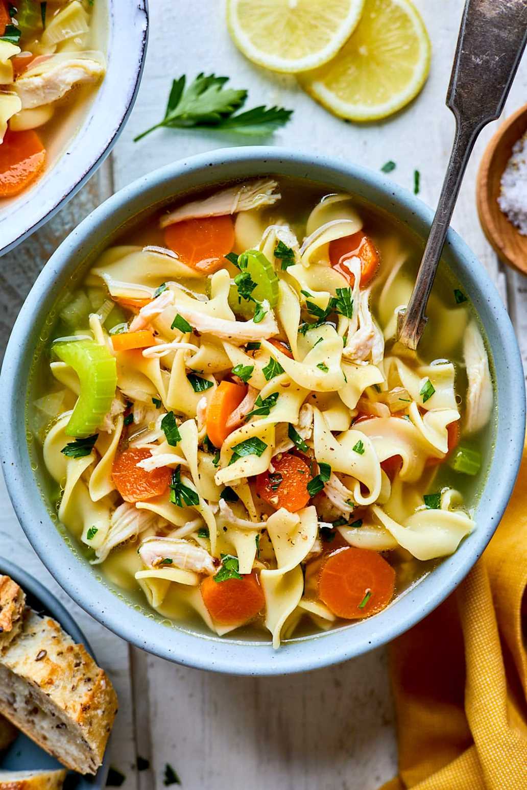 chicken noodle soup in bowl with spoon
