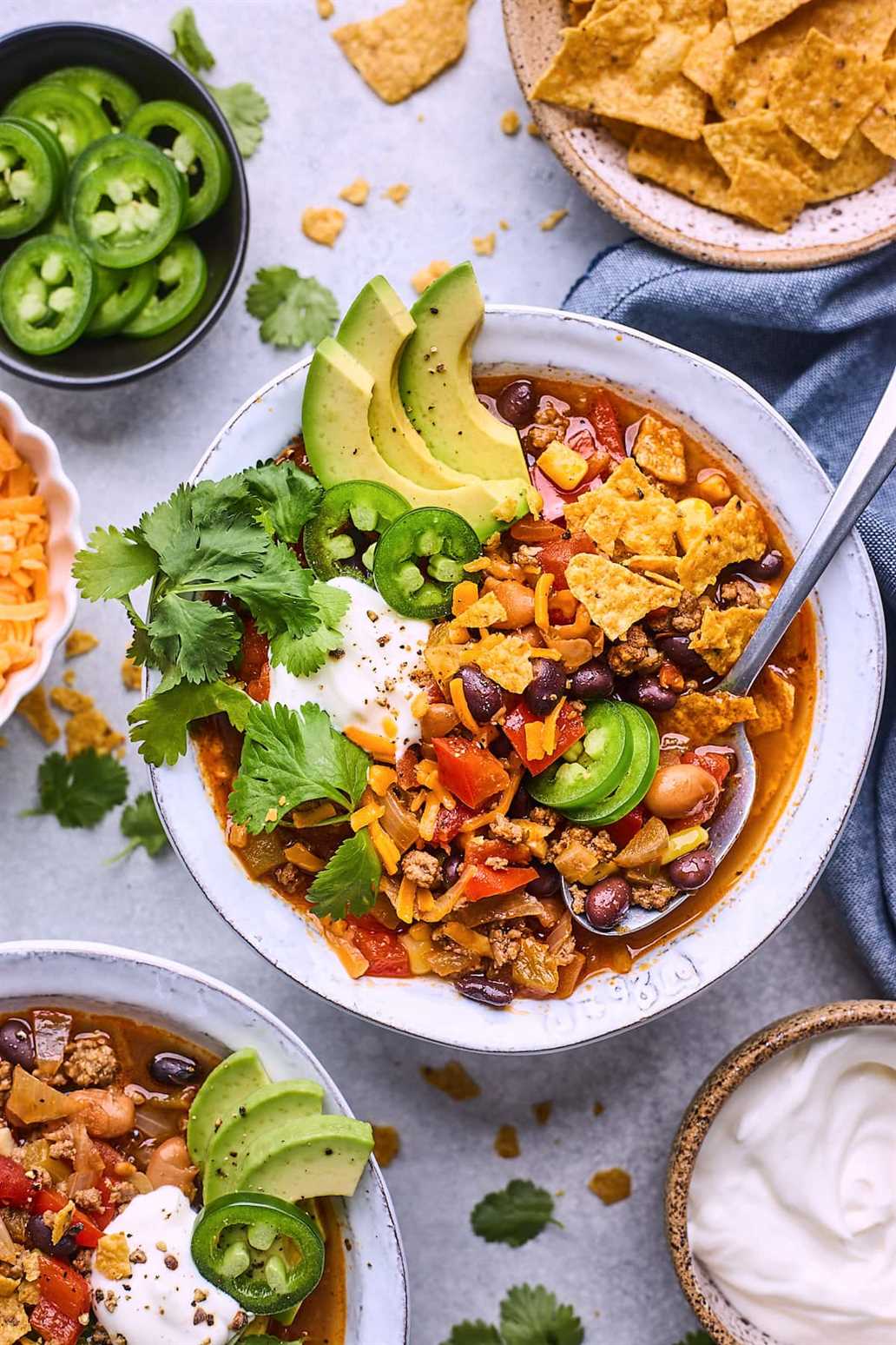 taco soup in a bowl with a spoon and toppings