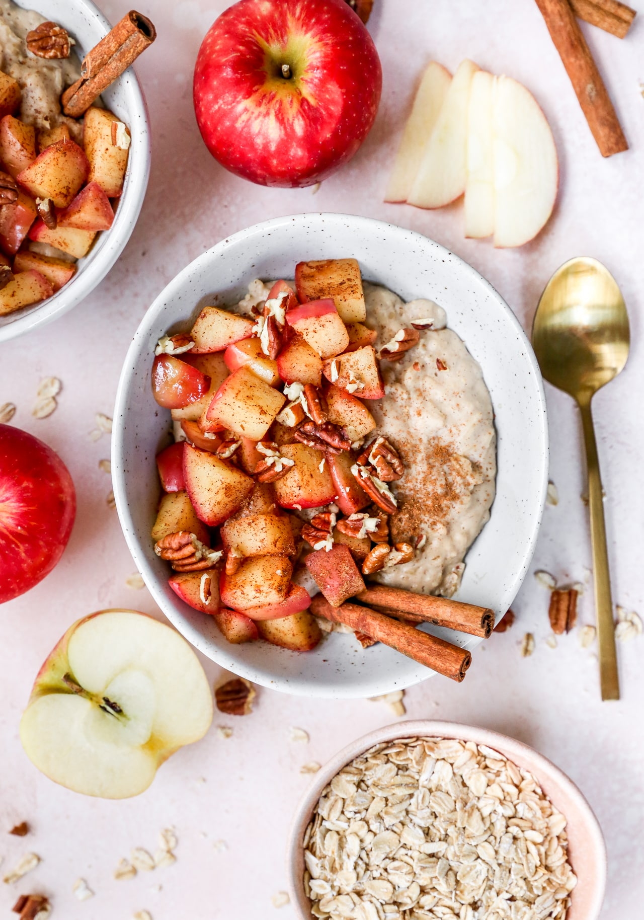 bowl of oatmeal topped with apple and pecans