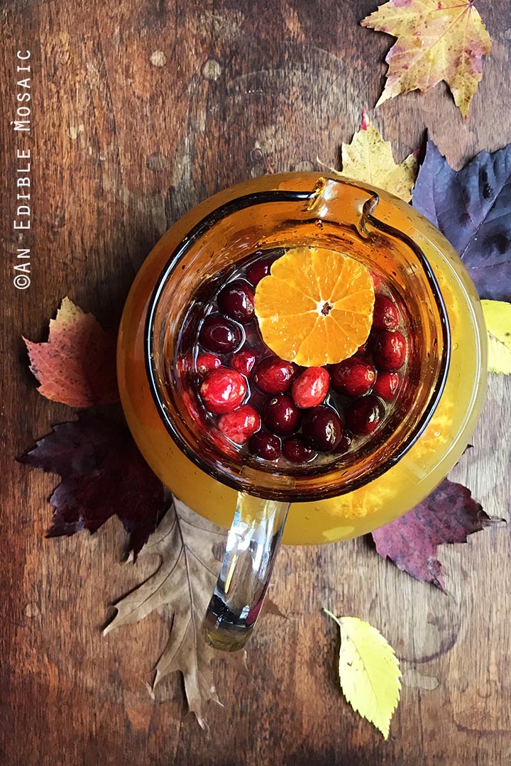 tangerine-lemonade-with-clove-infused-simple-syrup-and-fresh-cranberries-4